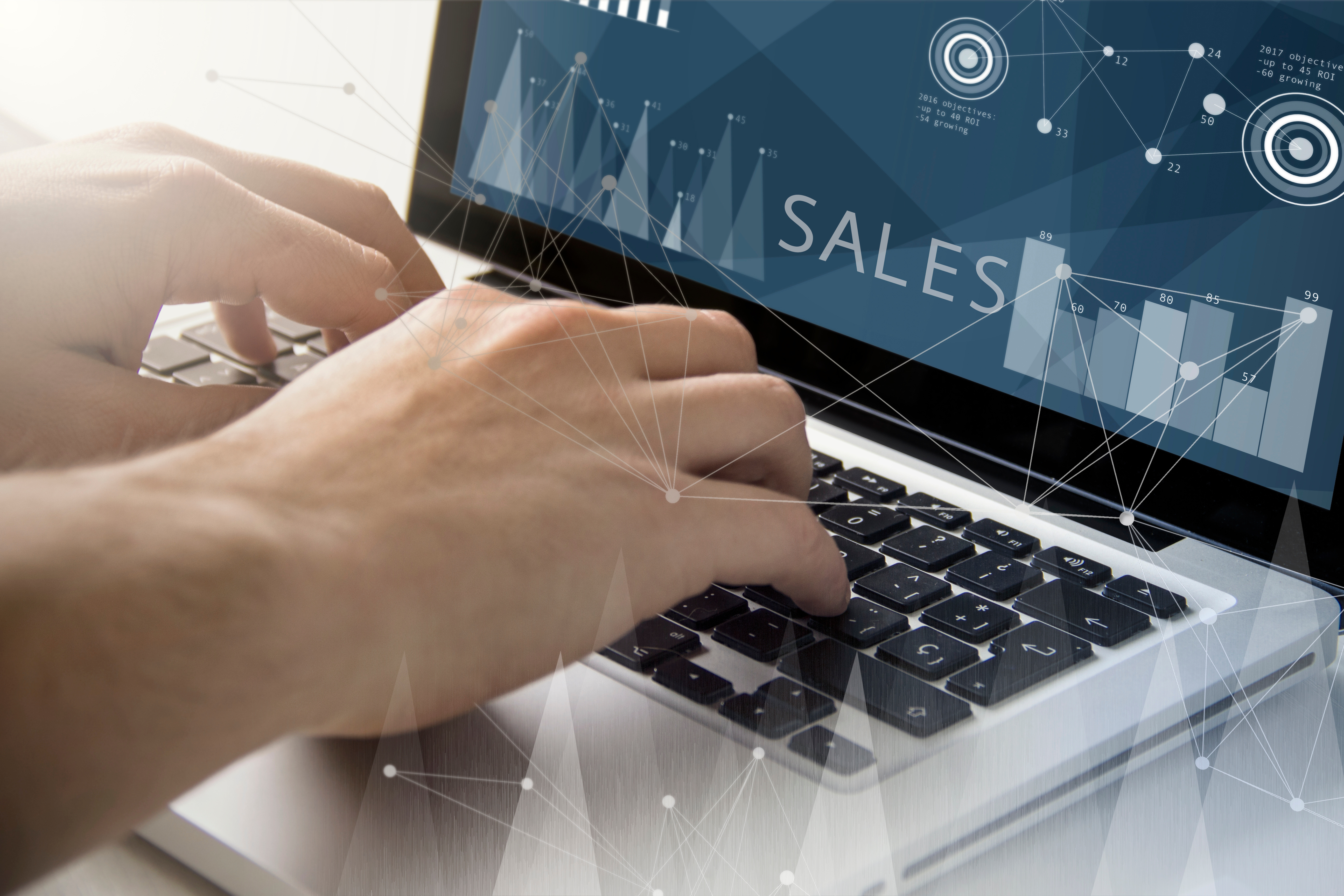 technology and business concept: man using a laptop with sales on the screen. All screen graphics are made up.